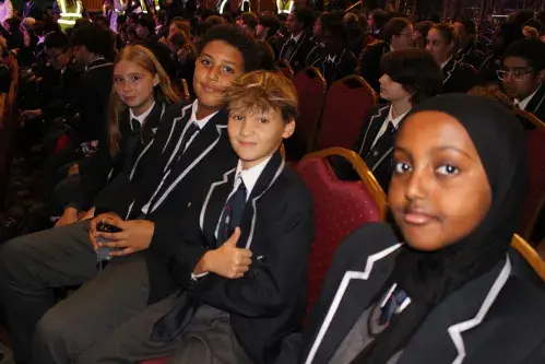 A group of four students smiling at the camera